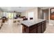 Open layout with kitchen island and dining area in the background at 30128 W Weldon Ave, Buckeye, AZ 85396