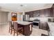 Spacious kitchen with granite island, stainless steel appliances, and dark wood cabinetry at 30128 W Weldon Ave, Buckeye, AZ 85396