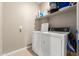 Efficient laundry room with washer, dryer and ample storage shelves at 30128 W Weldon Ave, Buckeye, AZ 85396