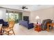Relaxing living room area featuring a ceiling fan and convenient access to the outdoor patio at 30128 W Weldon Ave, Buckeye, AZ 85396