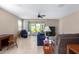 Comfortable living room with neutral colors, tiled floor, ceiling fan and natural light at 30128 W Weldon Ave, Buckeye, AZ 85396
