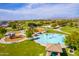 Aerial view of a colorful playground and splash pad in a community park, great for activities at 30128 W Weldon Ave, Buckeye, AZ 85396