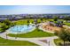 Aerial view of a fun splash pad and playground in a community park, perfect for Gathering enjoyment at 30128 W Weldon Ave, Buckeye, AZ 85396