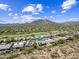 Drone shot of desert home with solar panels, putting green, pool, and views at 33317 N 71St St, Scottsdale, AZ 85266