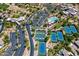 Expansive aerial view of a desert community with a pool, tennis courts, and clubhouse at 33317 N 71St St, Scottsdale, AZ 85266