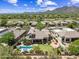 Beautiful aerial view of desert home with solar panels, putting green, sparkling pool, and mountain views at 33317 N 71St St, Scottsdale, AZ 85266