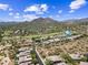 Scenic aerial view of a desert community with mountain views and lush green golf course at 33317 N 71St St, Scottsdale, AZ 85266