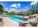 Serene backyard oasis with a refreshing pool, mature landscaping, and comfortable swing set for relaxation at 33317 N 71St St, Scottsdale, AZ 85266