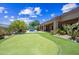 Backyard with a putting green, desert landscaping, swimming pool, and patio at 33317 N 71St St, Scottsdale, AZ 85266