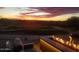Sunset view of golf course with firepit and outdoor seating, perfect for enjoying a relaxing evening at 33317 N 71St St, Scottsdale, AZ 85266