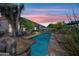Backyard oasis with a pool, desert landscape, and serene sunset views at 33317 N 71St St, Scottsdale, AZ 85266