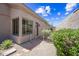 The side yard features desert landscaping with gravel, stones, and shrubs and access to a side entry gate at 33317 N 71St St, Scottsdale, AZ 85266