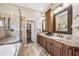 Luxurious bathroom with double sinks, granite countertops, and a glass-enclosed shower at 33317 N 71St St, Scottsdale, AZ 85266