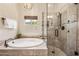 Bright bathroom showcases a large soaking tub and glass-enclosed shower with elegant tile at 33317 N 71St St, Scottsdale, AZ 85266