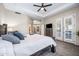 Inviting bedroom with a ceiling fan, dresser, and access to a private patio at 33317 N 71St St, Scottsdale, AZ 85266