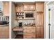Convenient butler's pantry with wooden cabinets, granite counters, and a built-in microwave at 33317 N 71St St, Scottsdale, AZ 85266