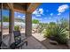 A covered patio with desert landscaping and an outdoor seating area at 33317 N 71St St, Scottsdale, AZ 85266