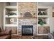 Stacked stone fireplace with decorative mantle and built-in shelves showcasing decorative items at 33317 N 71St St, Scottsdale, AZ 85266