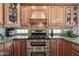 Close-up of kitchen area with stainless steel oven and glass tile backsplash at 33317 N 71St St, Scottsdale, AZ 85266