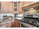 Close-up of kitchen area with stainless steel appliances, granite counters, and decorative backsplash at 33317 N 71St St, Scottsdale, AZ 85266