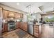 Bright kitchen features stainless appliances, granite countertops, and wood flooring at 33317 N 71St St, Scottsdale, AZ 85266