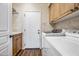 Bright laundry room featuring a sink, cabinets, and appliances at 33317 N 71St St, Scottsdale, AZ 85266