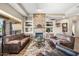 Inviting living room featuring a stone fireplace, built-in shelving, and designer furnishings at 33317 N 71St St, Scottsdale, AZ 85266