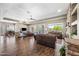 Spacious living room with hardwood floors, fireplace, and large windows overlooking backyard at 33317 N 71St St, Scottsdale, AZ 85266