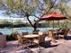 Outdoor seating area with umbrella-covered tables, perfect for enjoying a refreshing drink after a game at 33317 N 71St St, Scottsdale, AZ 85266
