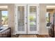 Interior view of double doors leading to a landscaped backyard with a patio and pool at 33317 N 71St St, Scottsdale, AZ 85266