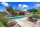 Charming backyard showcasing a pristine pool, patio with a swing, and lush desert plants at 33317 N 71St St, Scottsdale, AZ 85266