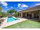 Inviting pool area with flagstone decking and a waterfall feature in a desert landscape at 33317 N 71St St, Scottsdale, AZ 85266