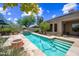 Relaxing backyard featuring a pool with stairs, desert landscaping, and covered seating area at 33317 N 71St St, Scottsdale, AZ 85266