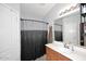 Well-maintained bathroom with a shower, vanity, and ample lighting, creating a clean and functional space at 42382 W Hillman Dr, Maricopa, AZ 85138