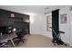 Bright bedroom featuring a brick accent wall and modern desk setup at 42382 W Hillman Dr, Maricopa, AZ 85138