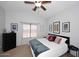 Comfortable bedroom with ceiling fan, neutral decor, and framed art, providing a relaxing and inviting space at 42382 W Hillman Dr, Maricopa, AZ 85138