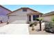 Charming single-story home with a well-manicured lawn and a two-car garage at 42382 W Hillman Dr, Maricopa, AZ 85138