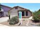 Charming single-story home with a well-manicured lawn and mature landscaping at 42382 W Hillman Dr, Maricopa, AZ 85138