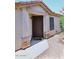 Inviting entryway with a charming front door and manicured landscaping at 42382 W Hillman Dr, Maricopa, AZ 85138