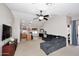 Spacious living room featuring neutral walls and tile floors. Open to kitchen at 42382 W Hillman Dr, Maricopa, AZ 85138