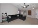 Open concept living room with tile floors, natural light, and a comfortable sectional sofa at 42382 W Hillman Dr, Maricopa, AZ 85138