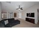 Bright living room with a modern ceiling fan, neutral walls, and ample natural light at 42382 W Hillman Dr, Maricopa, AZ 85138