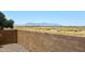 The backyard block wall provides beautiful views of the open desert with mountain views, offering privacy and tranquility at 42382 W Hillman Dr, Maricopa, AZ 85138