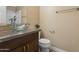 Bathroom featuring a granite countertop, glass bowl sink, and white toilet at 4601 N 102Nd Ave # 1055, Phoenix, AZ 85037