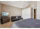 Bedroom with vaulted ceiling, neutral carpet, closet, and a pull out couch at 4601 N 102Nd Ave # 1055, Phoenix, AZ 85037