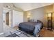 Bedroom with neutral walls, and a grey accent rug with large grey bed at 4601 N 102Nd Ave # 1055, Phoenix, AZ 85037
