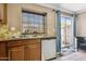 Kitchen sink area with stainless steel appliances, tile backsplash, and a view to the outside at 4601 N 102Nd Ave # 1055, Phoenix, AZ 85037