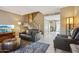 Comfortable living room with a staircase, neutral colors, and access to the kitchen area at 4601 N 102Nd Ave # 1055, Phoenix, AZ 85037