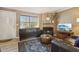 Comfortable living area with a fireplace, tv, and a large window for natural light at 4601 N 102Nd Ave # 1055, Phoenix, AZ 85037