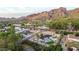 Aerial view of the property showcasing the backyard pool, patio, lush landscaping, and mountain views at 4633 N 49Th Pl, Phoenix, AZ 85018